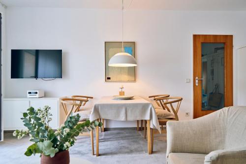 a living room with a table and chairs at Vier Häuser in Norderney