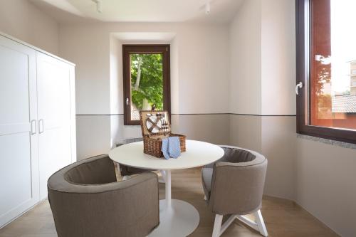 a dining room with a white table and two chairs at Villa Il Platano in Como