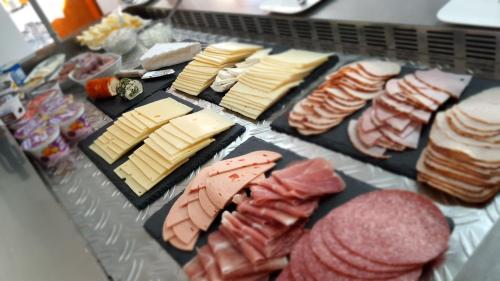 a tray of meats and cheese and other foods at Hotel Schneiderhof in Braunlage