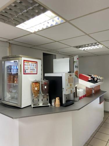 a kitchen with two machines on a counter at Premi&egrave;re Classe Montlu&ccedil;on Saint Victor in Saint-Victor