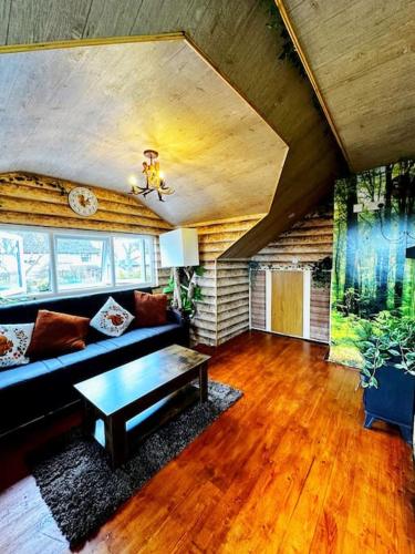 a living room with a couch and a table at Squirrel Hideaway with Hot Tub in Formby, Liverpool in Formby