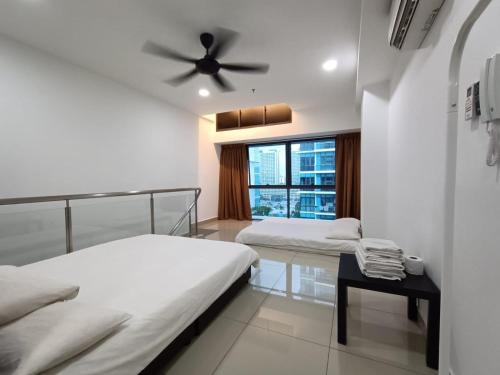 a bedroom with two beds and a ceiling fan at Pacific Towers Star Seksyen 13 PJ Jaya One Parking Pool Kitchen in Petaling Jaya