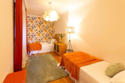 a small room with two beds and a television at PISO EN COMBARRO A 1º LINEA DE COSTA in Combarro