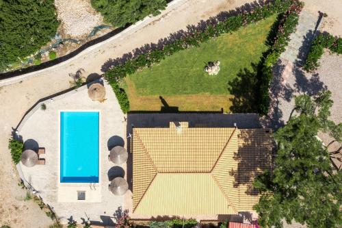 an overhead view of a house with a swimming pool at Villa in the Woods in Kolimbia