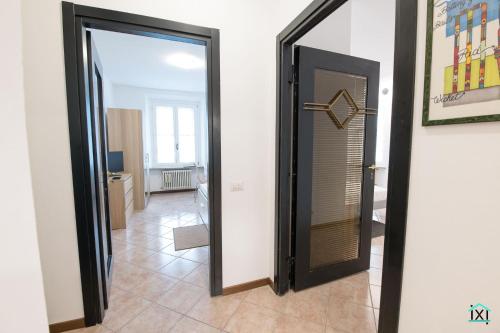a hallway with a door and a mirror at Attico Varese centro - Ixihome in Varese