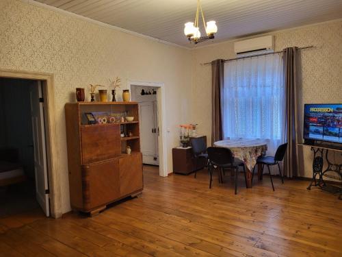 a living room with a table and chairs and a television at Summer cottage in Jurmala in Jūrmala