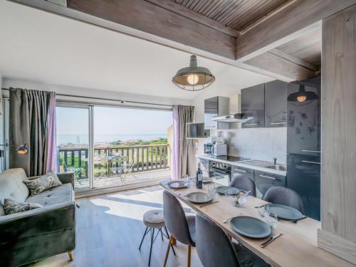 une cuisine et un salon avec une table et des chaises dans l'établissement Apartment Les Eaux Vives 1 & 2-2 by Interhome, à Saint Pierre La Mer