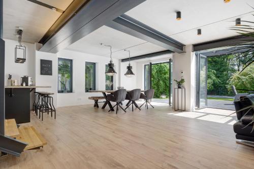 an open living room with a dining table and chairs at Studio mt nine in Neu Wulmstorf