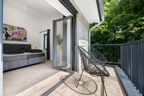 a chair on the balcony of a house at Studio mt nine in Neu Wulmstorf