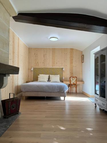 a bedroom with a bed and a fireplace at Chateau Eck in Cadaujac