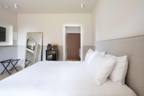 a bedroom with a large white bed with white pillows at Villa Il Platano in Como