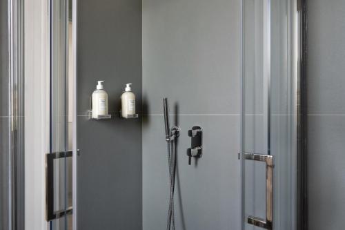 a bathroom with a shower with two soap bottles at Villa Il Platano in Como