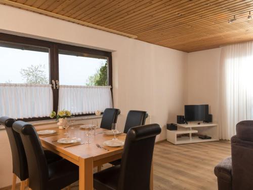a dining room with a table and chairs at Apartment Eifelnatur - Haus 2-1 by Interhome in Immerath