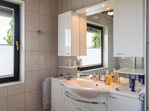 a bathroom with a sink and a mirror at Apartment Eifelnatur - Haus 2-1 by Interhome in Immerath