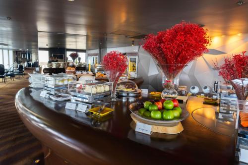 a buffet with fruits and vegetables on a table at Tower Club at lebua in Bangkok