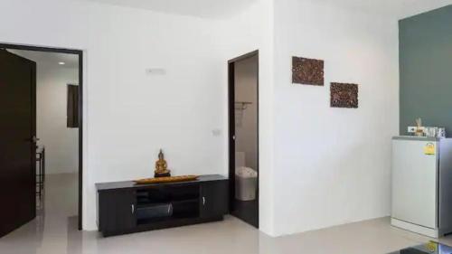 a room with a white wall with a refrigerator at Villa VV Lamai Koh Samui in Koh Samui 