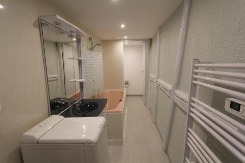 a bathroom with a sink and a mirror at L'Appartement - Cœur de Riquewihr - 2 à 4 personnes in Riquewihr
