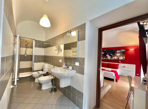 a bathroom with a toilet and a sink at CANTU' SUITE in Catania