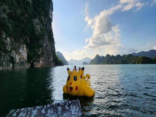 a large yellow boat in a body of water at Halo Retreat in Hòa Bình