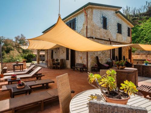 a patio with tables and chairs and a building at Apartment Stelle by Interhome in Trappeto