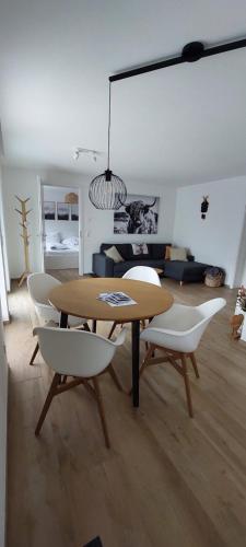 a dining room with a table and white chairs at Irgendwo im Schwarzwald in Elzach