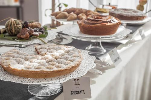 a buffet of pies and pastries on a table at Marconi Hotel in Rende