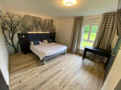 a bedroom with a bed and a window at Relais Saint Michel in Saint-Michel