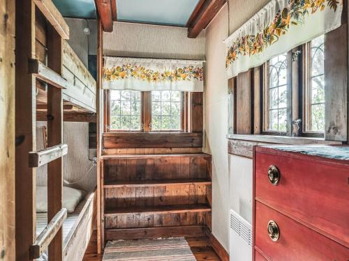 a staircase in a room with a bunk bed and windows at Holiday Home Alice by Interhome in Tällberg