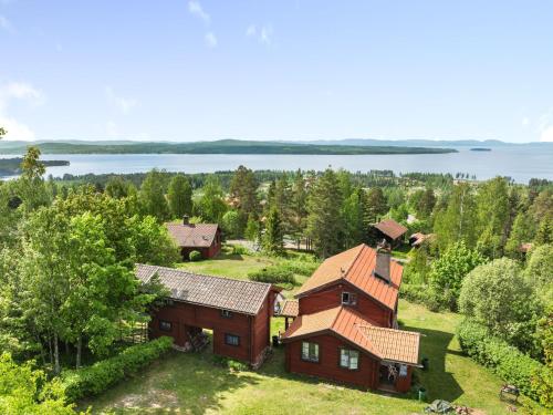 an aerial view of a house with a lake in the background at Holiday Home Alice by Interhome in Tällberg