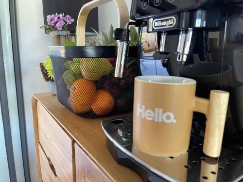 a coffee cup sitting on a counter next to a hello coffee machine at Le Jacquier Life House in Saint-Pierre