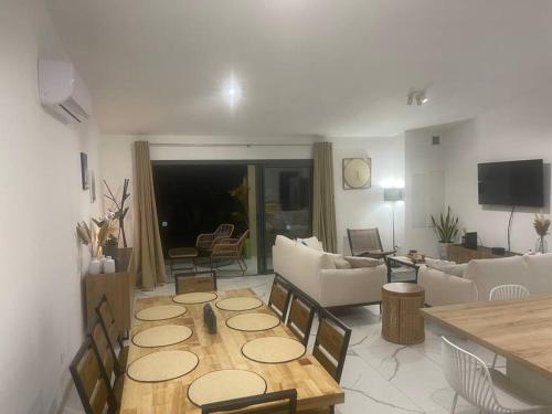 a living room with a couch and a table at Le Jacquier Life House in Saint-Pierre