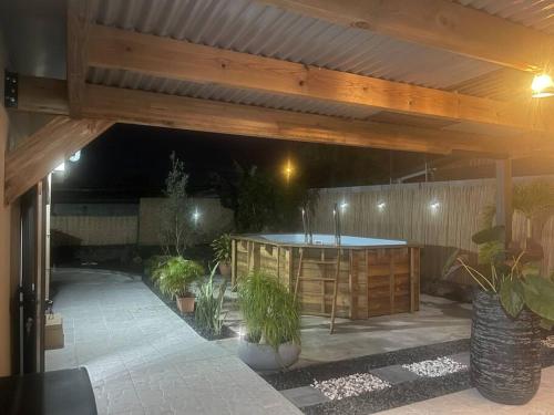 an outdoor patio with a table and potted plants at Le Jacquier Life House in Saint-Pierre