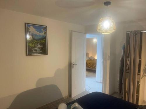 a room with a bed and a picture on the wall at Le Jacquier Life House in Saint-Pierre