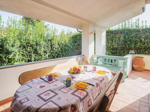 a table with a plate of fruit on a patio at Holiday Home Orchidea by Interhome in Camaiore