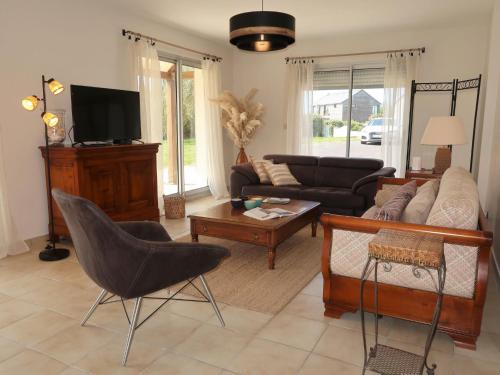 a living room with a couch and a table at Holiday Home Cremiou Beach by Interhome in Kerlouan