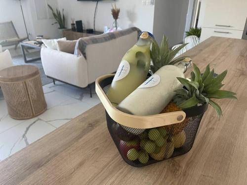 a basket filled with fruit on top of a table at Le Jacquier Life House in Saint-Pierre