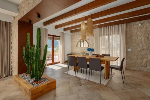 a dining room with a table and a cactus at Hotel Forza Mare in Kotor