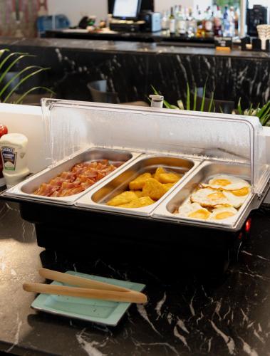 a tray of food on top of a counter at Stic Urban Hotel & SPA in San Antonio