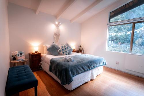 a bedroom with a bed and a large window at Ora Retreat in Queenstown