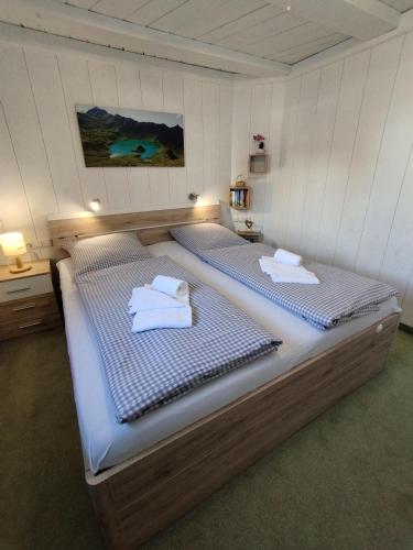 a bedroom with two beds with towels on them at Der Sonnenhof - Ferienwohnungen in Obermaiselstein