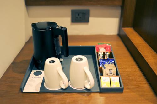 a coffee maker sitting on top of a table at Pride Elite Haridwar in Haridwār