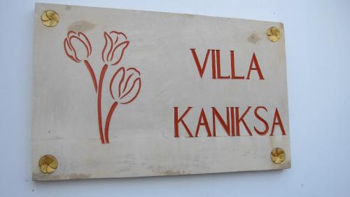 a sign that reads villa kanska with flowers on it at Villa Kaniksa in Candidasa