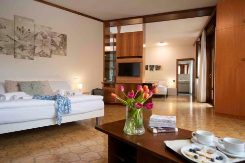 a hotel room with a bed and a table with flowers at SunLake Hotel in Riva del Garda