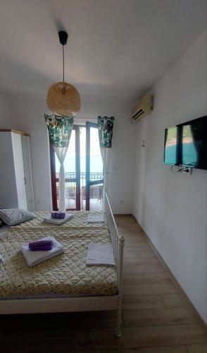 a bedroom with a bed with towels on it at Joković Accommodation in Kotor