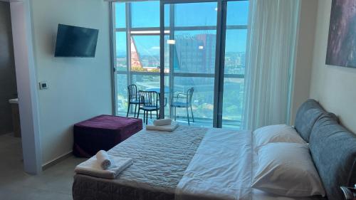 a bedroom with a bed and a table and chairs at STAY-FIVE rooms & apartments in Shkodër