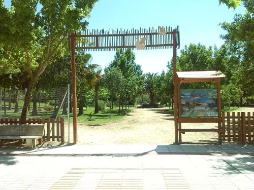 a park with a bench and a playground at Camping las Catalinas in Ríolobos