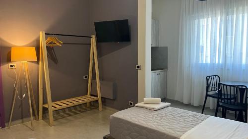 a bedroom with a bed and a table and chairs at STAY-FIVE rooms & apartments in Shkodër