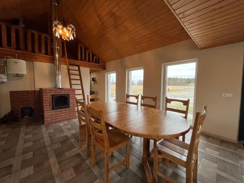 a dining room with a wooden table and chairs at Банный дом in Liikva