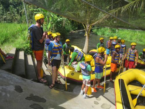 a group of people in yellow helmets standing next to a raft at Villa Kaniksa in Candidasa