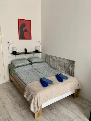 a bedroom with a bed with two blue towels on it at Dob street cute condo in Budapest